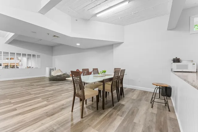 a view of a dining room with furniture and wooden floor