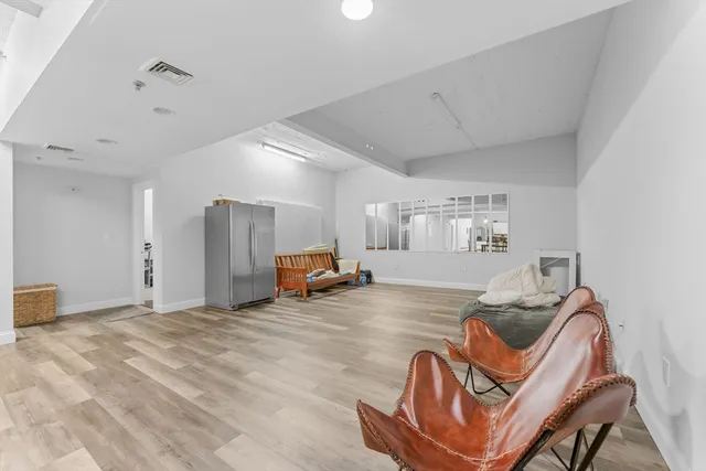a view of a livingroom with furniture and windows
