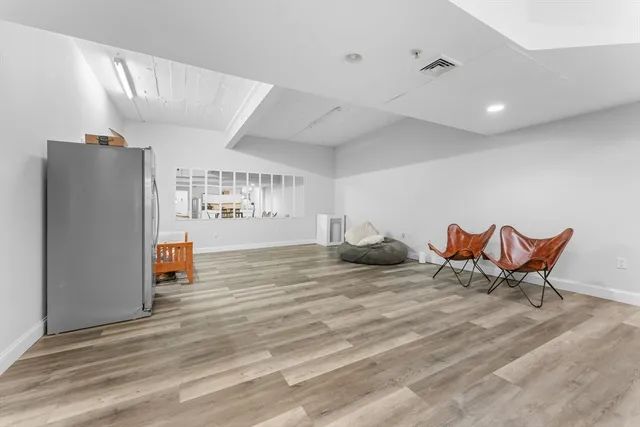 a view of a room with furniture and wooden floor