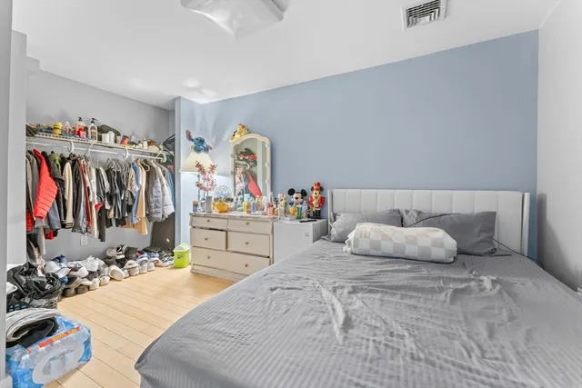 a bedroom with bed and a large mirror