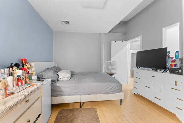 a bedroom with furniture and a flat screen tv