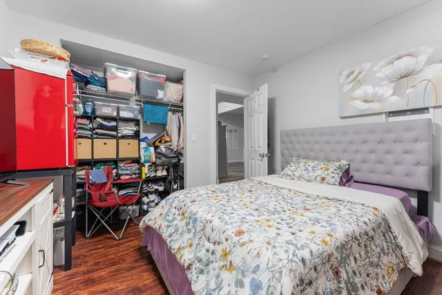 a bedroom with a bed and a bookshelf