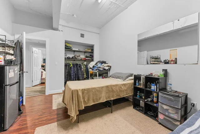 a bedroom with a bed and a chandelier