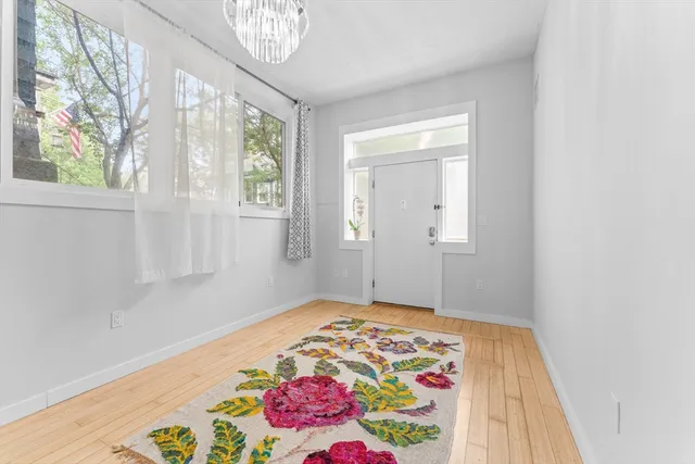 a view of an empty room with window and cabinet
