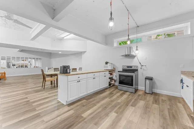 a kitchen with a stove a sink and a refrigerator