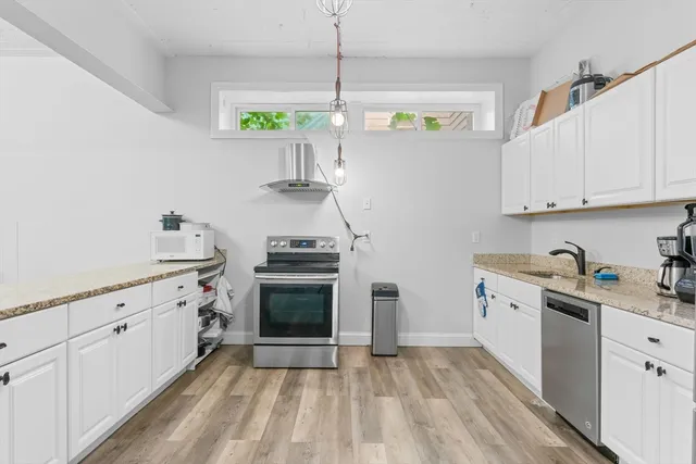 a kitchen with stainless steel appliances a stove a sink and a refrigerator