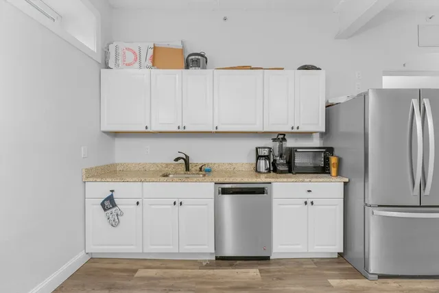 a kitchen with stainless steel appliances granite countertop a refrigerator sink and cabinets