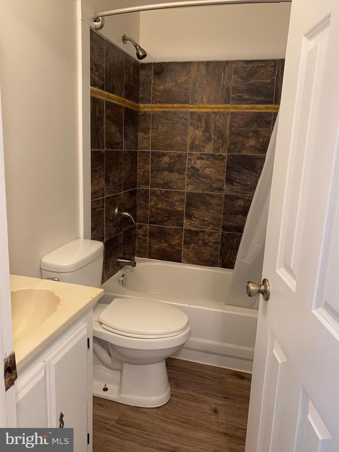 323 East Chestnut Street, Unit 5 Coatesville, PA 19320 - Photo 4 of 7 a bathroom with a toilet and a shower