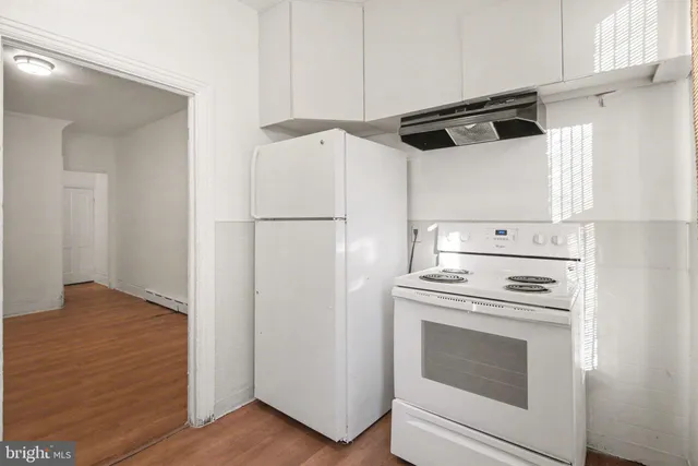 a view of a kitchen with electric appliances