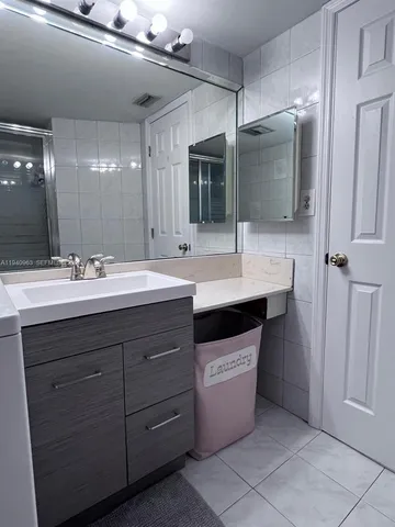 a bathroom with a sink double vanity and a mirror