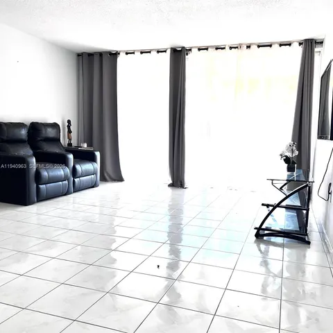 a living room with a couch and a rug