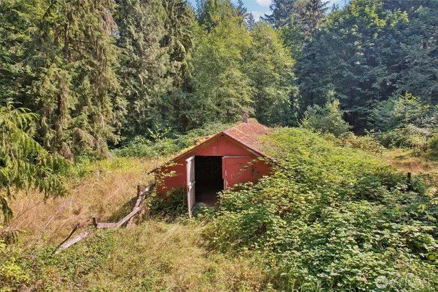 front view of a house with a yard and large trees