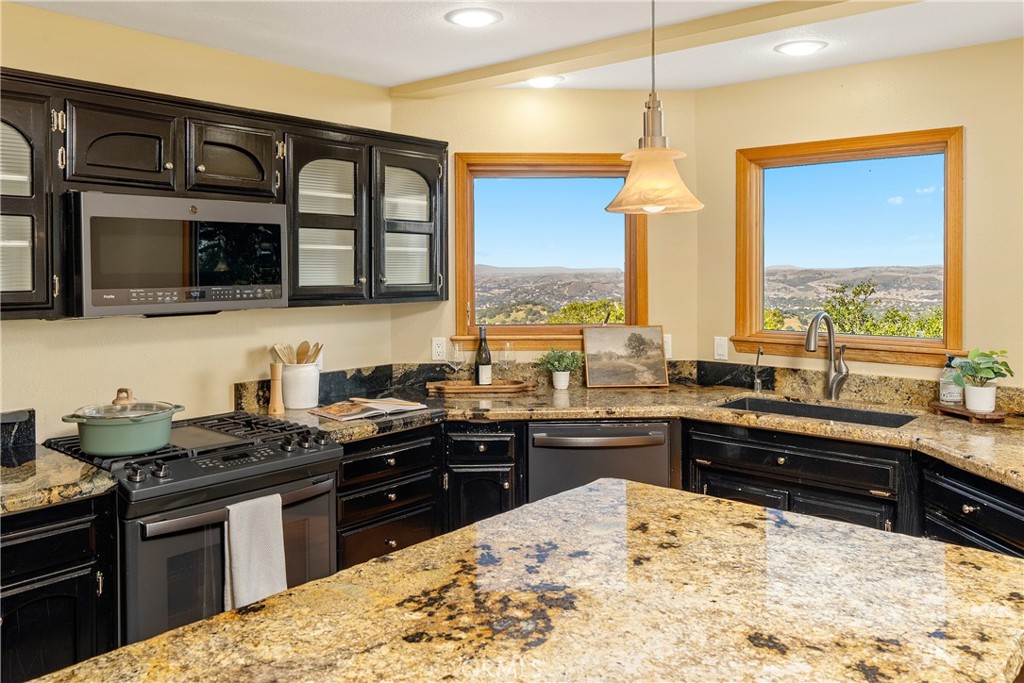 10885 San Marcos Road Atascadero, CA 93422 - Photo 13 of 63 a kitchen with stainless steel appliances kitchen island granite countertop a sink and cabinets