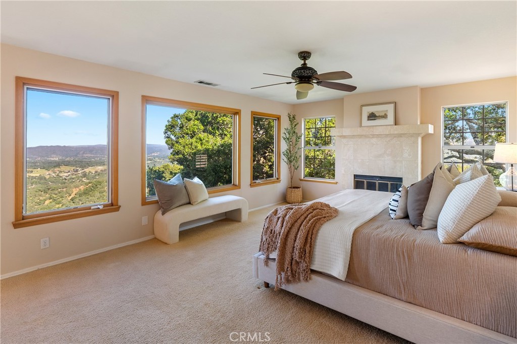 10885 San Marcos Road Atascadero, CA 93422 - Photo 21 of 63 a spacious bedroom with a large bed and a large window