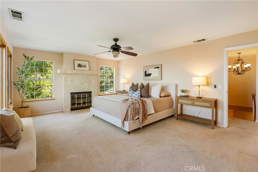 10885 San Marcos Road Atascadero, CA 93422 - Photo 22 of 63 a spacious bedroom with a bed and a fireplace