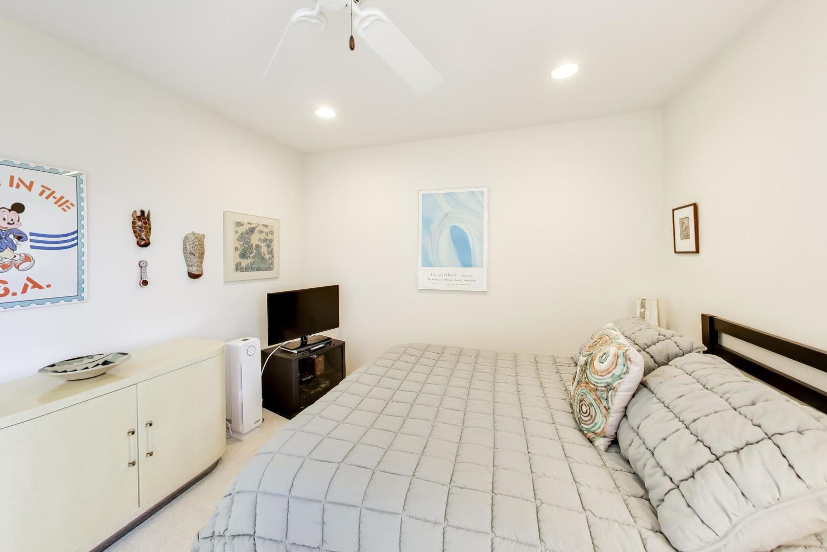 495 Milford Road Deerfield, IL 60015 - Photo 21 of 33 a bedroom with a bed and a flat tv screen on the dresser