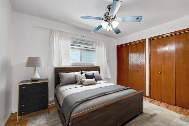 a bedroom with a large bed and a chandelier