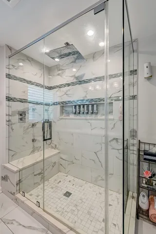 a bathroom with a shower and a mirror