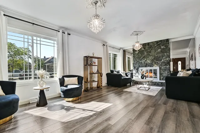 a living room with furniture and a chandelier
