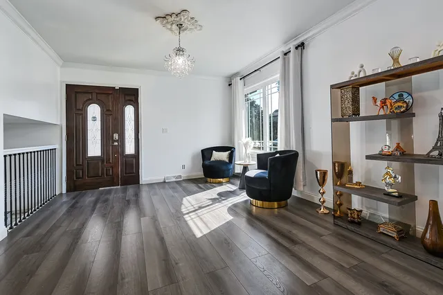 a view of a workspace with wooden floor and furniture