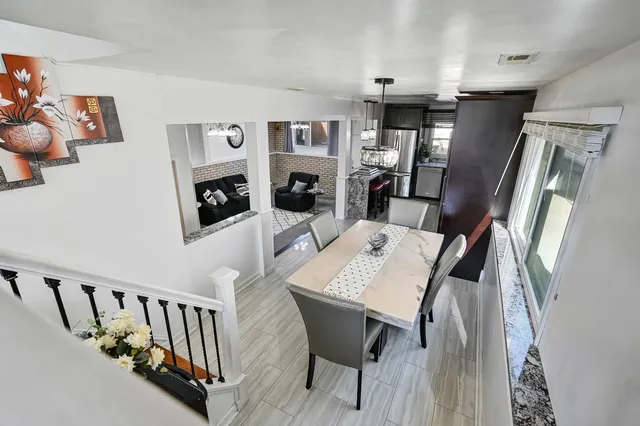 a view of a dining room with furniture window and wooden floor