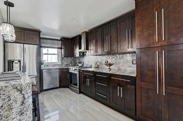 a kitchen with stainless steel appliances granite countertop a refrigerator sink and cabinets