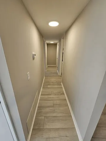 an empty room with a hardwood and a window