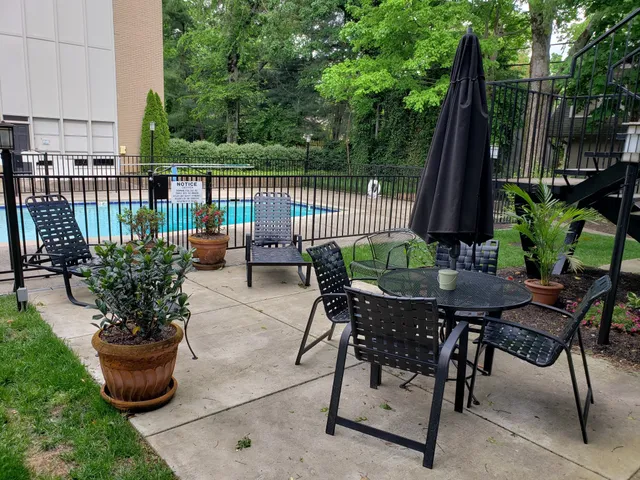 a view of a patio with a table and chairs under an umbrella