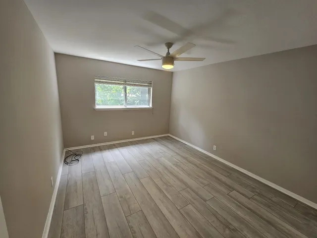 wooden floor in an empty room with a mirror