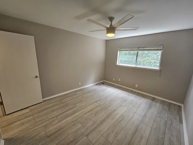 a view of walk in closet with clothes