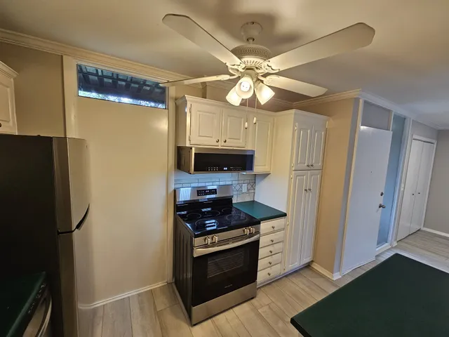 a kitchen with metallic refrigerator freezer and a dishwasher