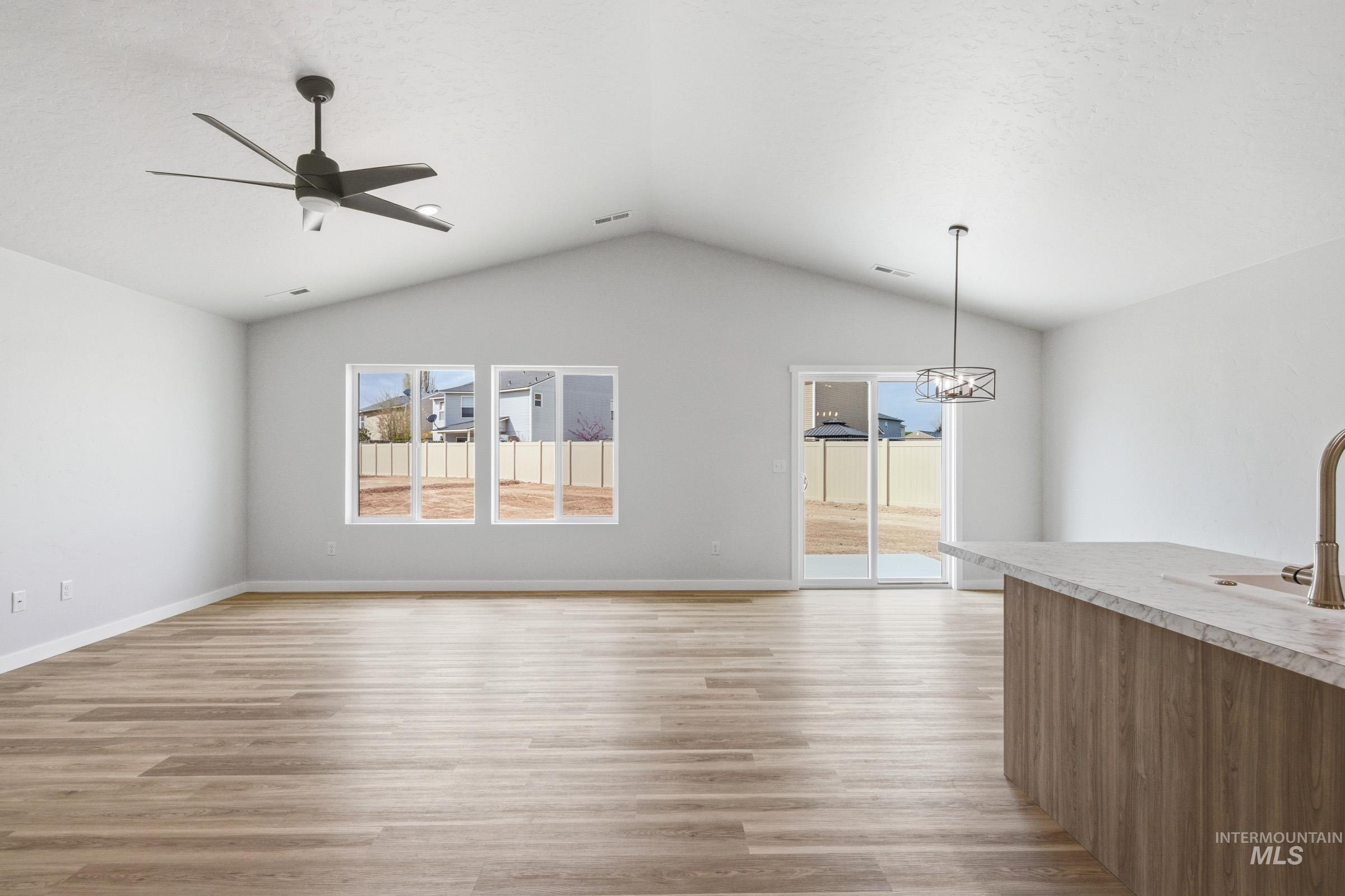 13735 Inman Court Caldwell, ID 83607 - Photo 10 of 20 Unfurnished living room featuring light wood-style flooring and a ceiling fan