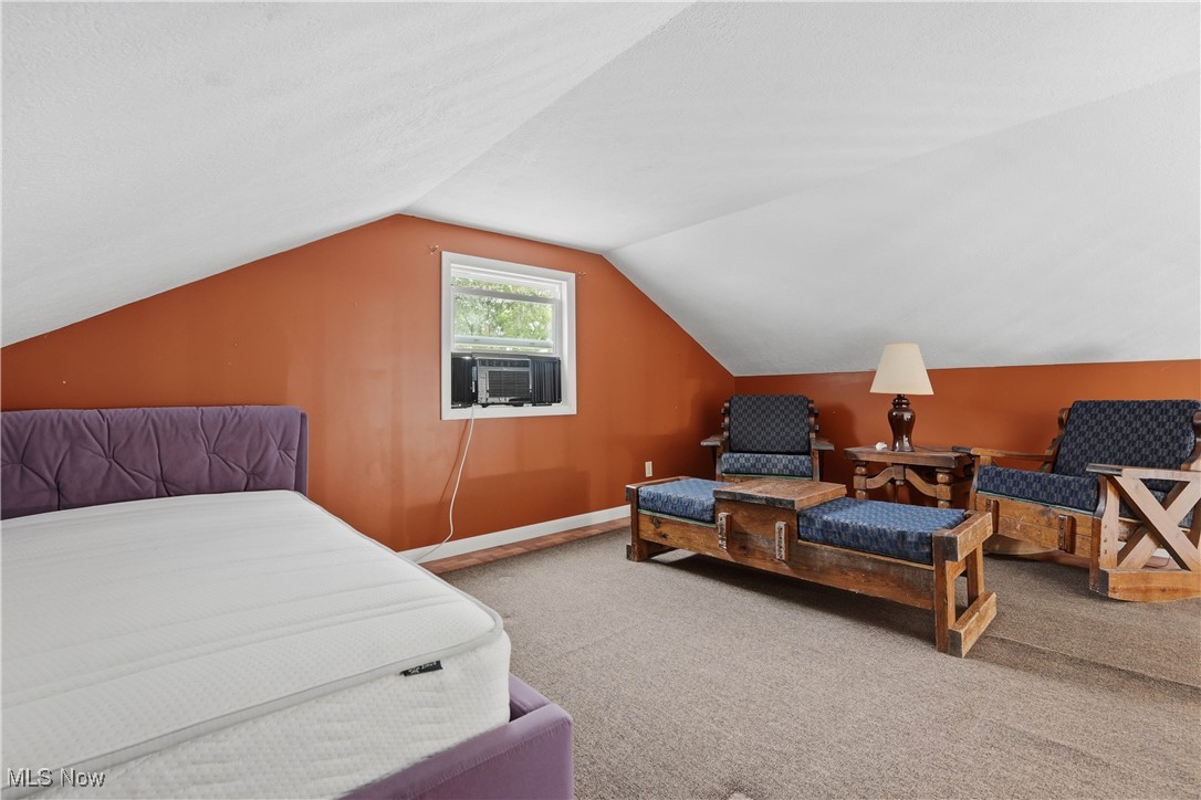 4254 Doral Road Southwest Carrollton, OH 44615 - Photo 32 of 46 Bedroom featuring carpet, lofted ceiling, cooling unit, and a textured ceiling