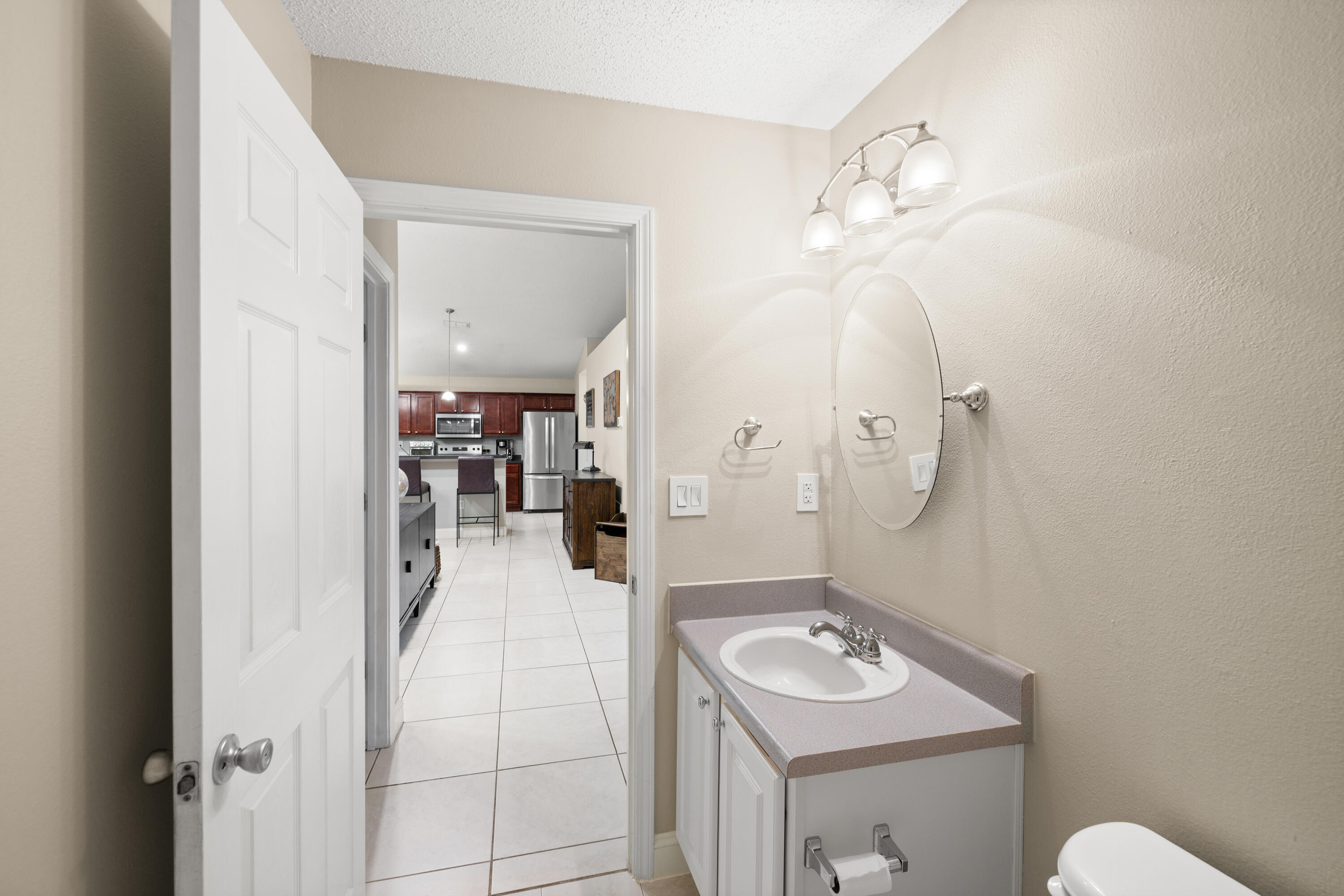 202 Limestone Circle Crestview, FL 32539 - Photo 30 of 49 a bathroom with a sink a mirror and a shower