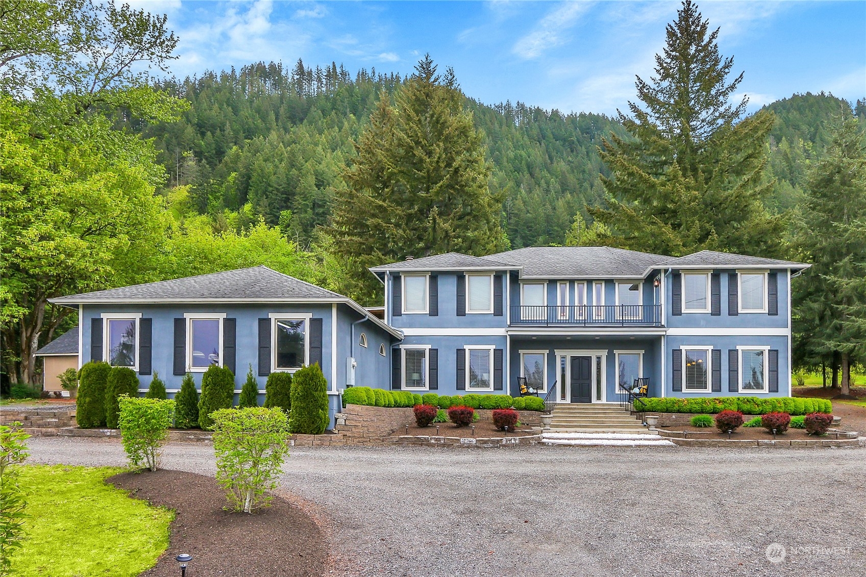 13921 Jim Creek Road Arlington, WA 98223 - Photo 1 of 35 a front view of a brick house with a yard garden and outdoor seating