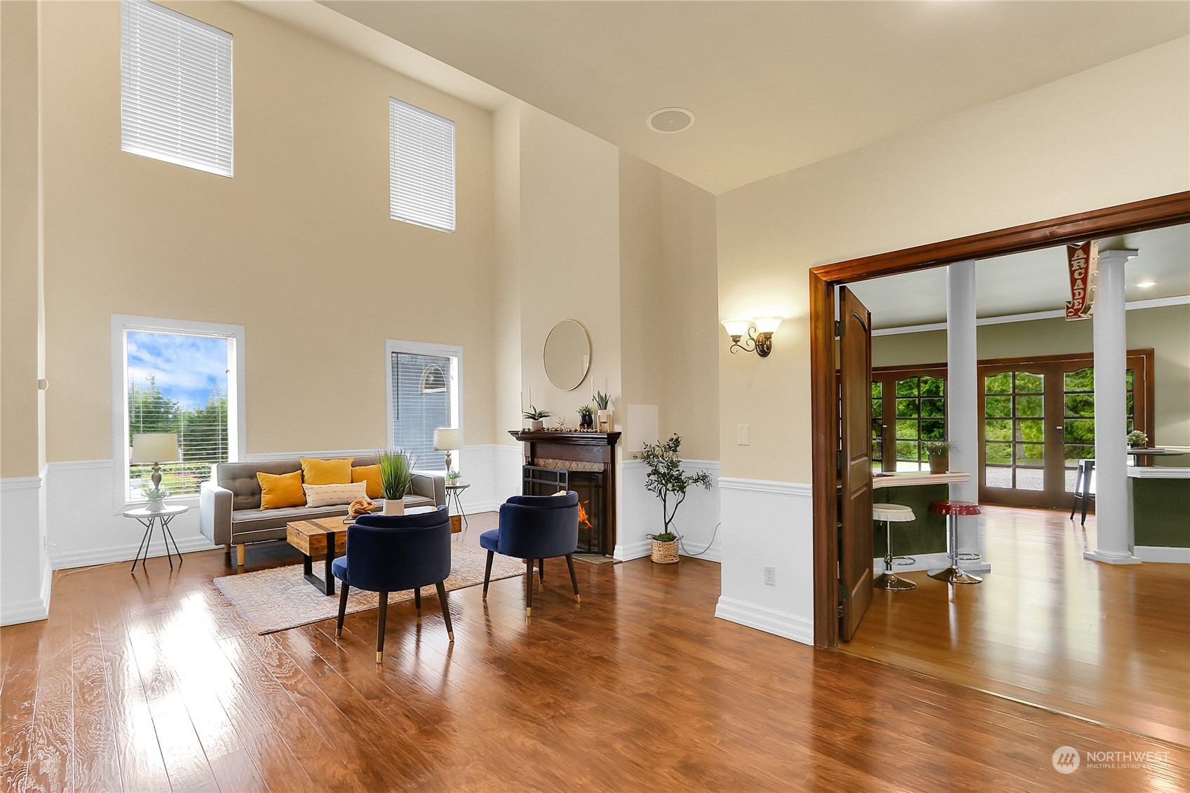 13921 Jim Creek Road Arlington, WA 98223 - Photo 11 of 35 a living room with furniture and wooden floor next to a large window