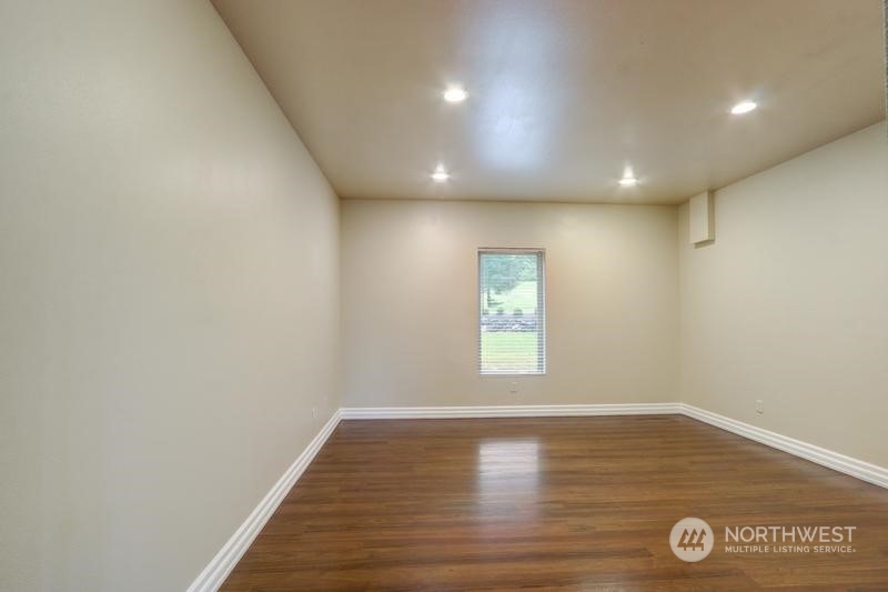 13921 Jim Creek Road Arlington, WA 98223 - Photo 14 of 35 a view of empty room with window and wooden floor