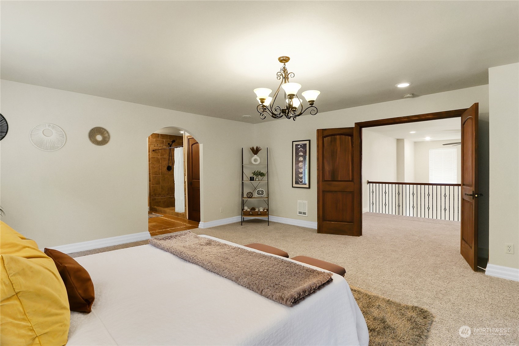 13921 Jim Creek Road Arlington, WA 98223 - Photo 23 of 35 a spacious bedroom with a bed and a chandelier