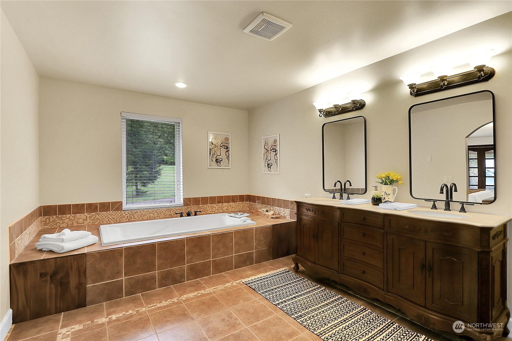 13921 Jim Creek Road Arlington, WA 98223 - Photo 24 of 35 a spacious bathroom with a tub sink and mirror
