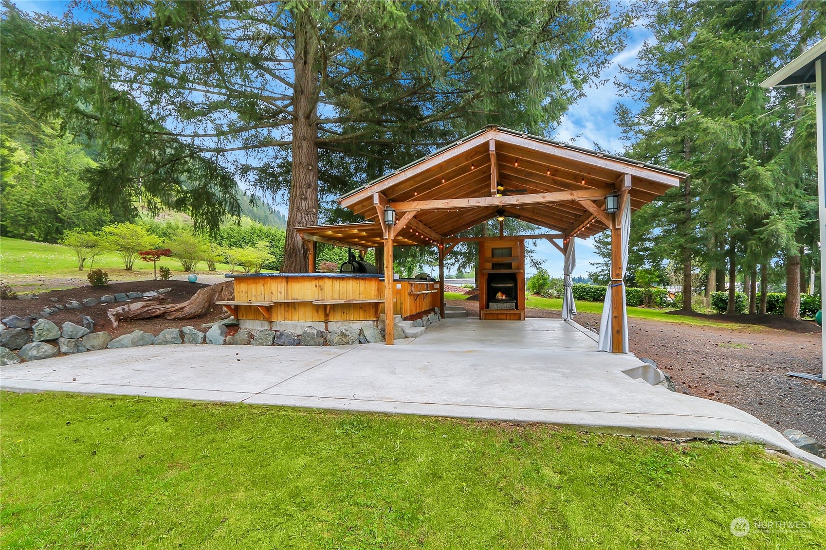 13921 Jim Creek Road Arlington, WA 98223 - Photo 30 of 35 a view of a house with backyard and sitting area