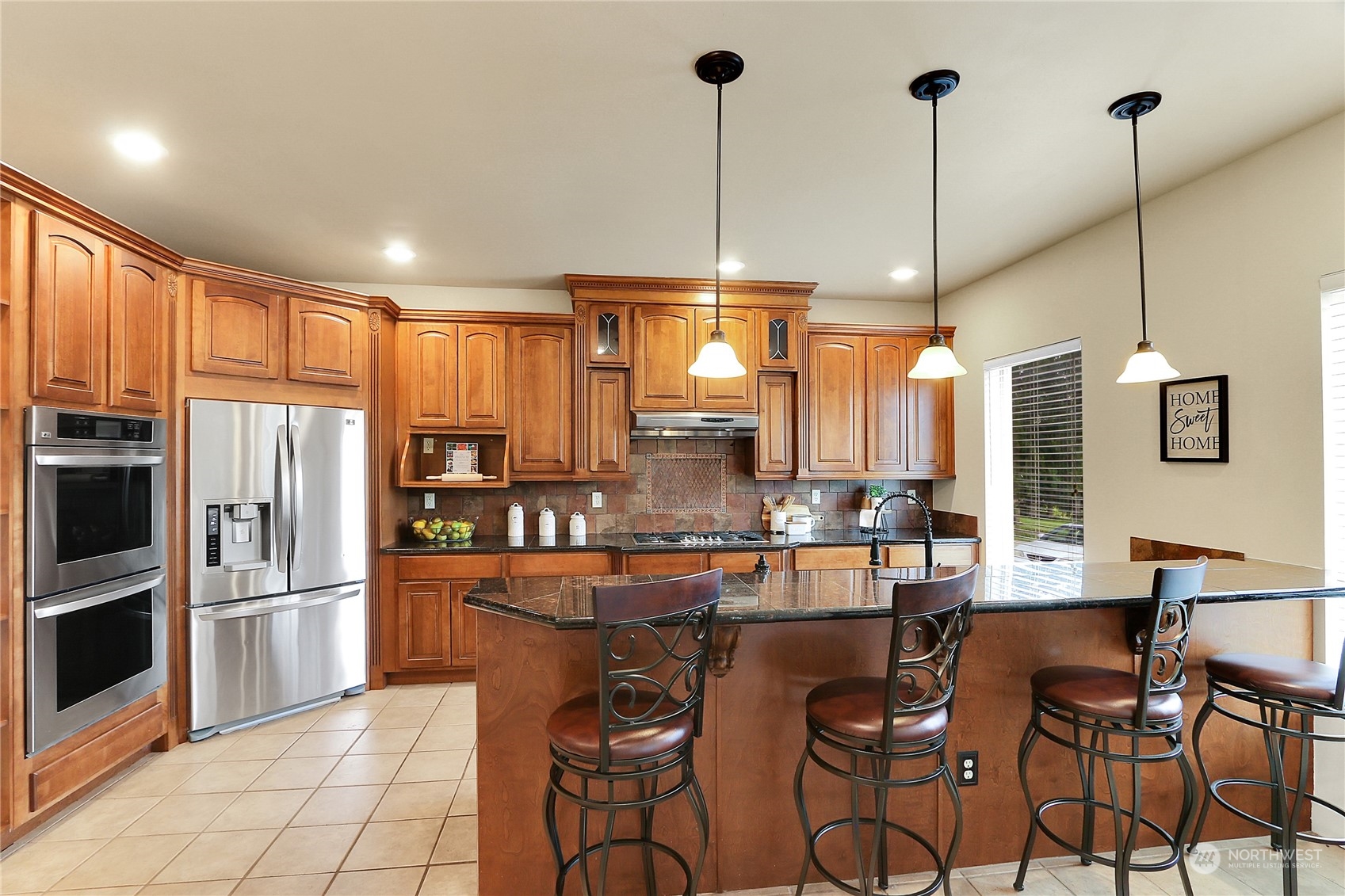 13921 Jim Creek Road Arlington, WA 98223 - Photo 3 of 35 a dining table chairs and a kitchen view