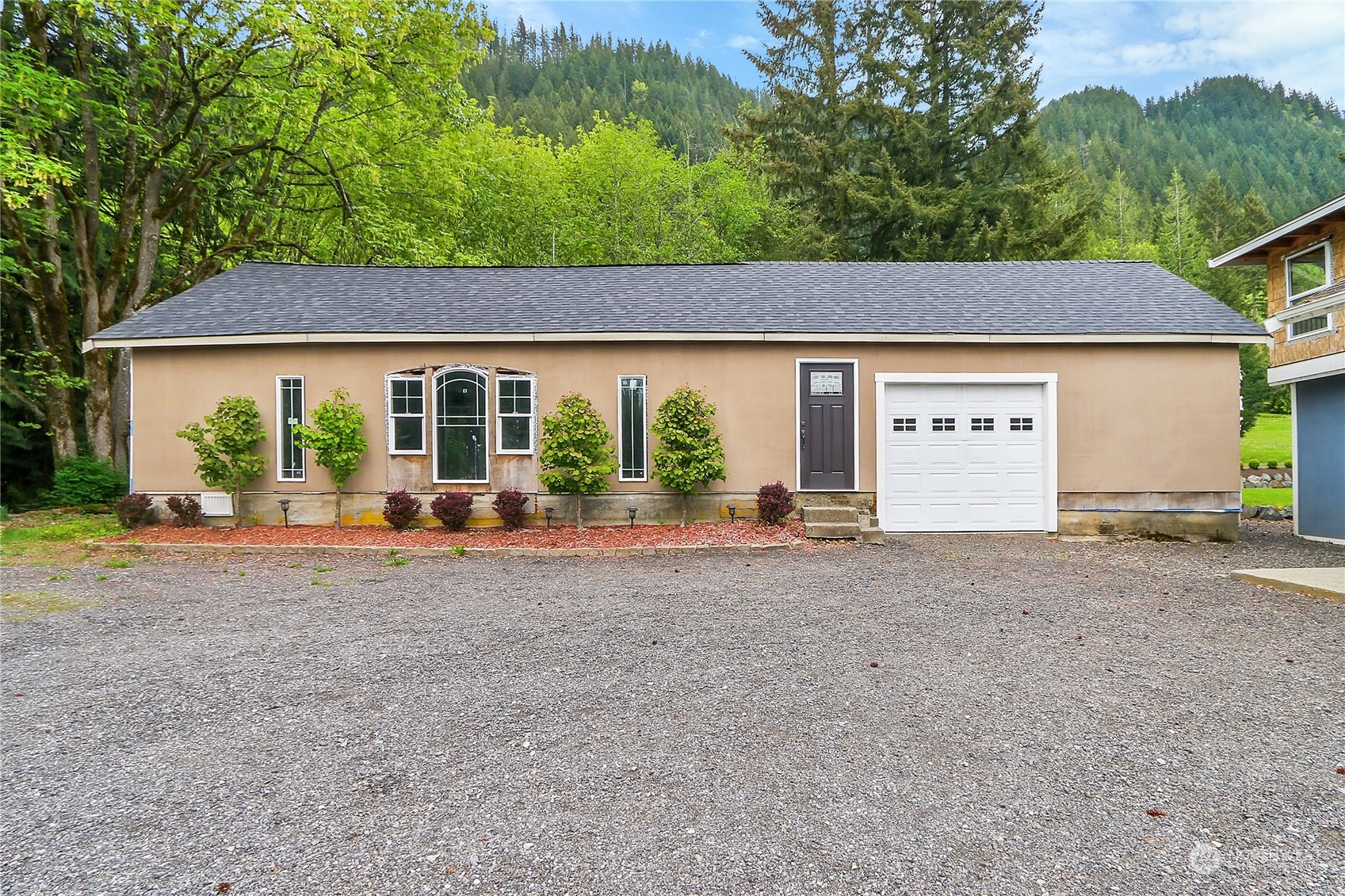13921 Jim Creek Road Arlington, WA 98223 - Photo 32 of 35 a view of a house with backyard and a tree