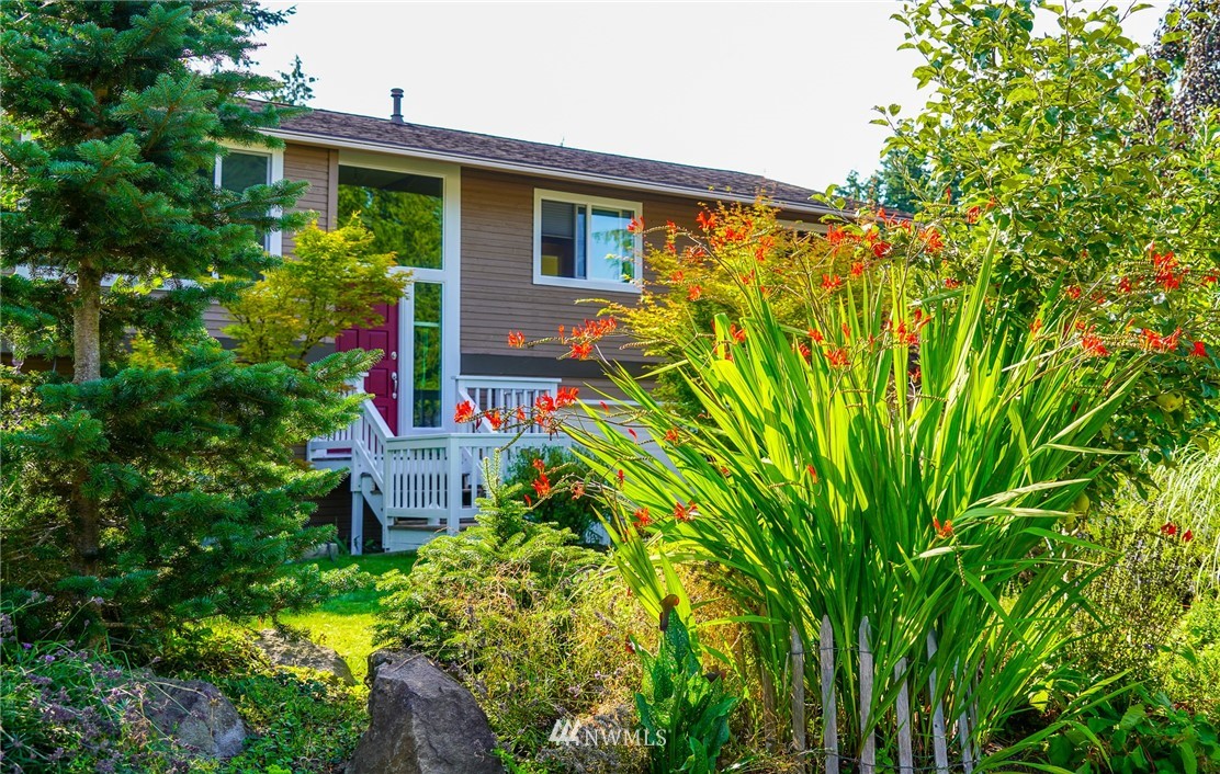 21812 2nd Avenue Southeast Bothell, WA 98021 - Photo 1 of 25 a flower garden is sitting in front of a house