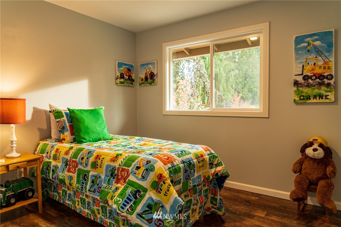 21812 2nd Avenue Southeast Bothell, WA 98021 - Photo 15 of 25 a bedroom with a bed and a window