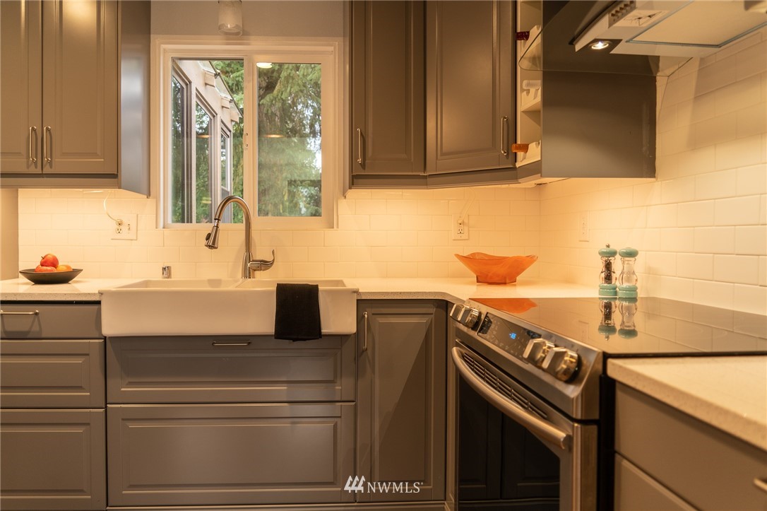 21812 2nd Avenue Southeast Bothell, WA 98021 - Photo 4 of 25 a kitchen with a sink stove and cabinets