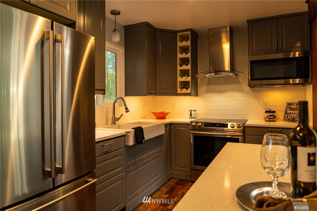 21812 2nd Avenue Southeast Bothell, WA 98021 - Photo 5 of 25 a kitchen with stainless steel appliances granite countertop a refrigerator and a sink