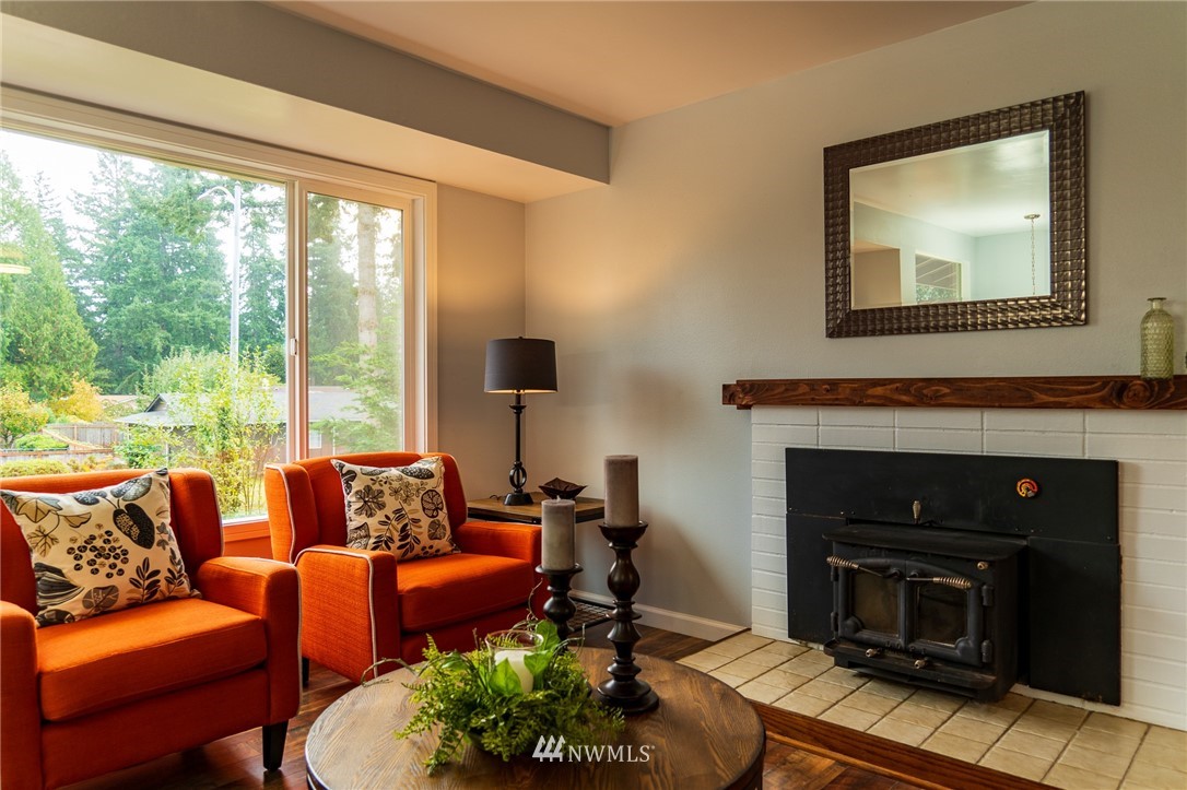 21812 2nd Avenue Southeast Bothell, WA 98021 - Photo 10 of 25 a living room with furniture a large window and a fireplace
