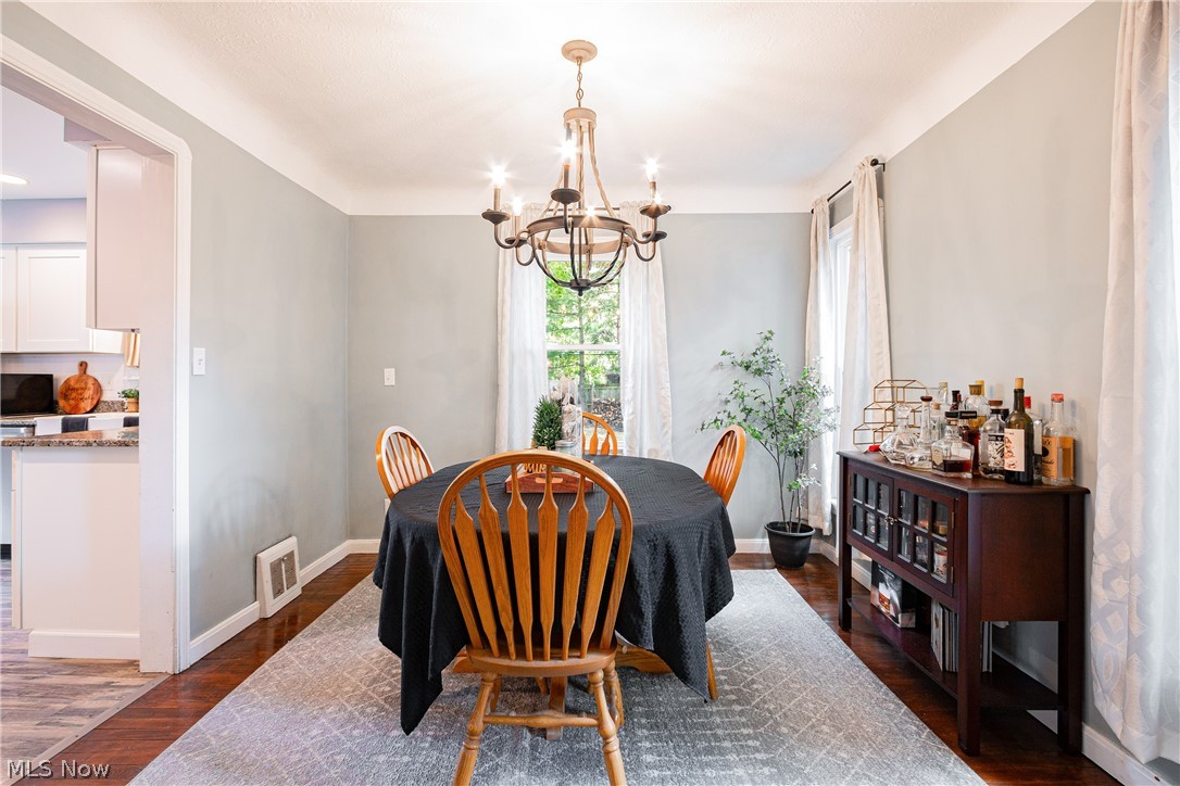 9630 Snow Road Cleveland, OH 44130 - Photo 15 of 31 Dining room with dark wood-type flooring and a notable chandelier