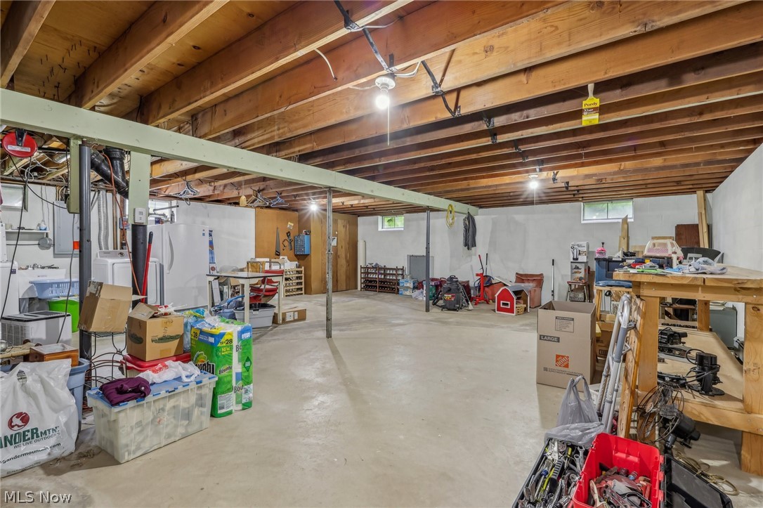 1762 Stonehaven Road Madison, OH 44057 - Photo 25 of 36 Basement featuring white fridge and a workshop area