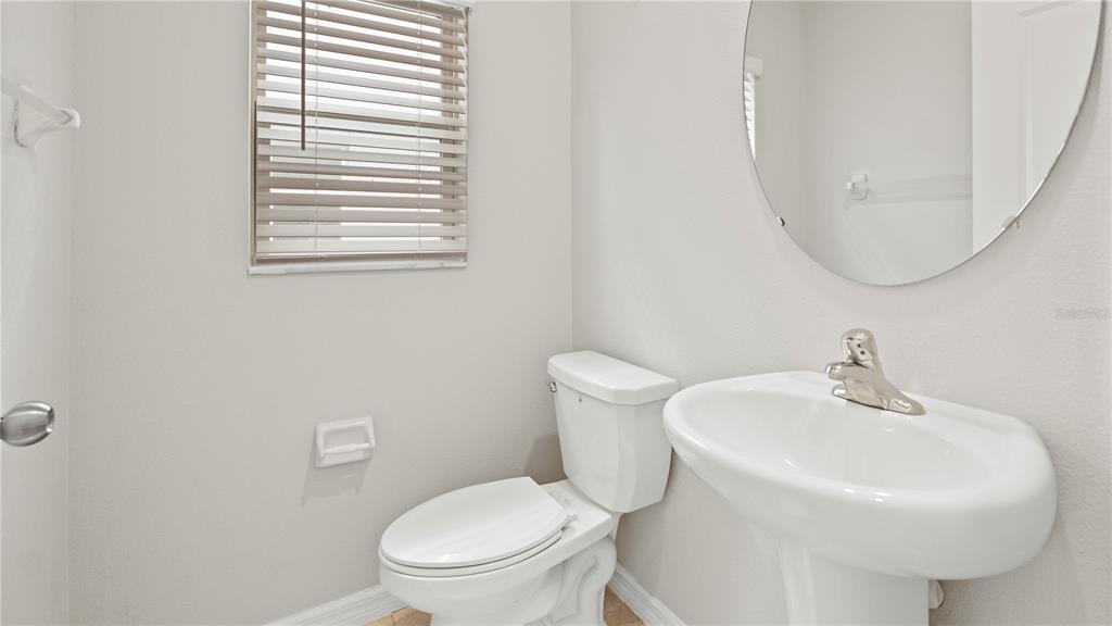 7231 Spring Snowflake Avenue Tampa, FL 33619 - Photo 16 of 46 a white toilet sitting next to a white sink